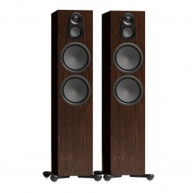 Perspective view of a pair of Monitor Audio Silver 500 7G floorstanding speakers in walnut finish with grilles removed.